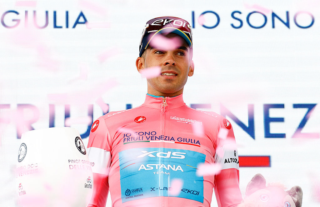 Thomas Silva (XDSAstana) celebrates on the podium after retaining the overall leader's pink jersey after the 3rd stage of the Giro d'Italia 2026. (Photo by Luca Bettini / AFP via Getty Images)