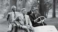 Ronald Reagan being driven on a golf cart