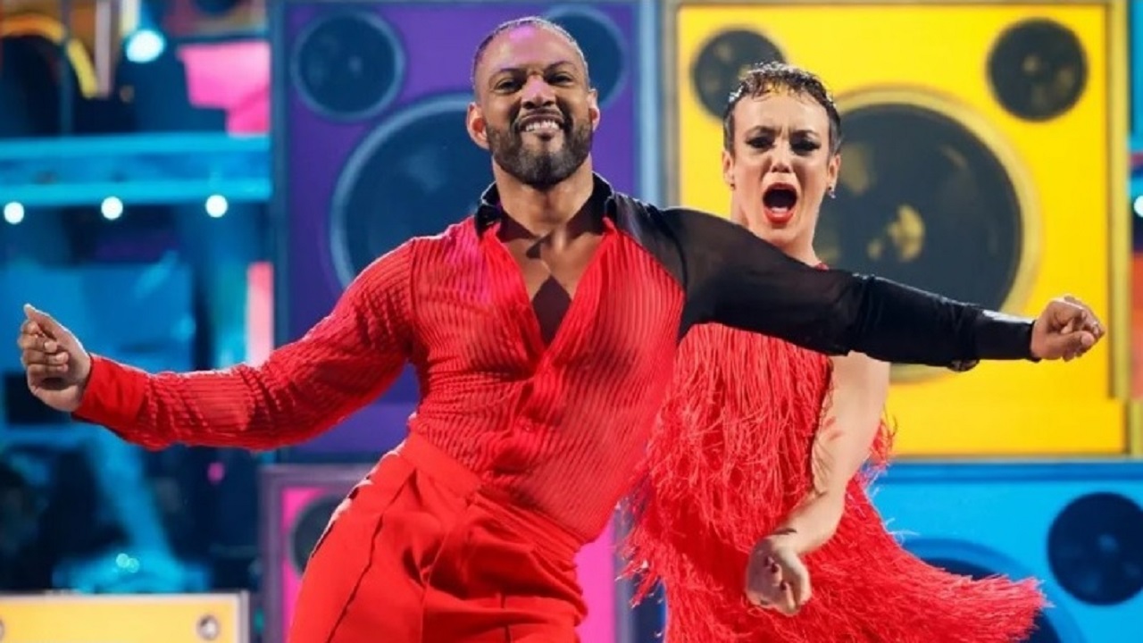 JB Gill and dancer Lauren Oakley dressed in fiery red, performing to a hip-swaying samba routine to Red Alert by Basement Jaxx in the Strictly Come Dancing 2024 semi-finals