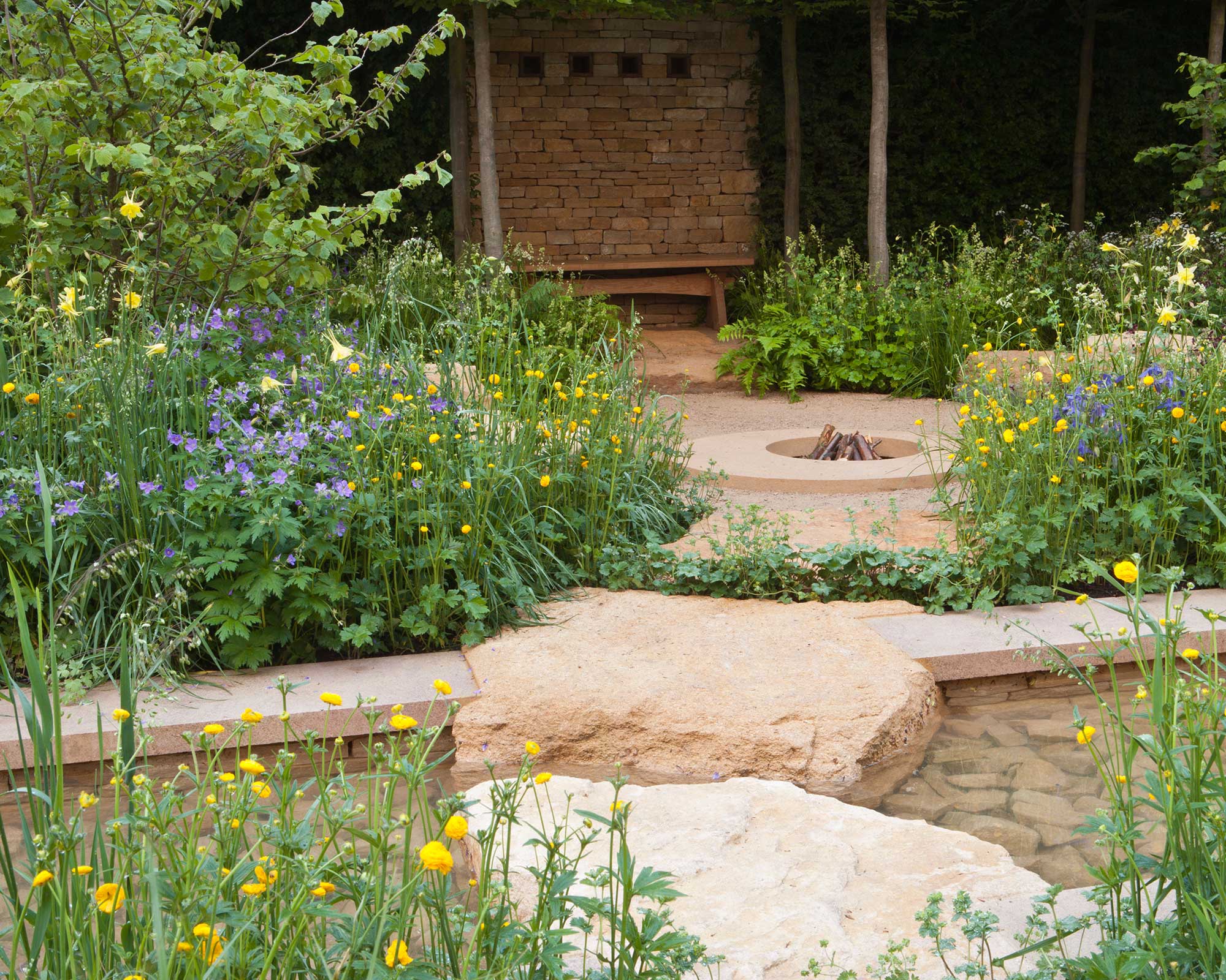 large stepping stones and stone fire pit at Lands' End – A Rural Muse Designer: Adam Frost at chelsea flower show 2021