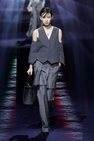 model in skirts over pants and gray cape at Fendy fall winter 2023