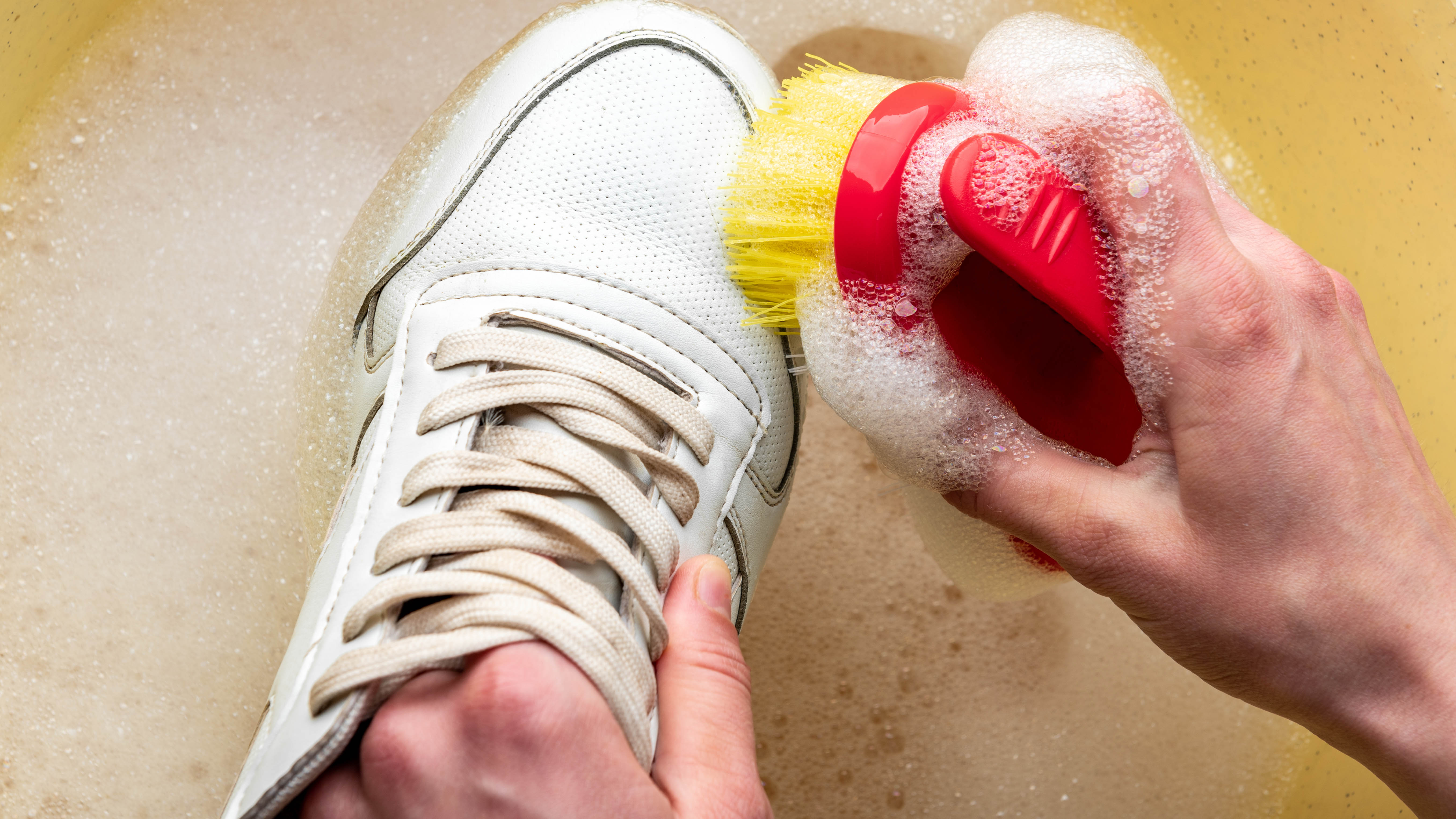 Cleaning sneakers in soapy water