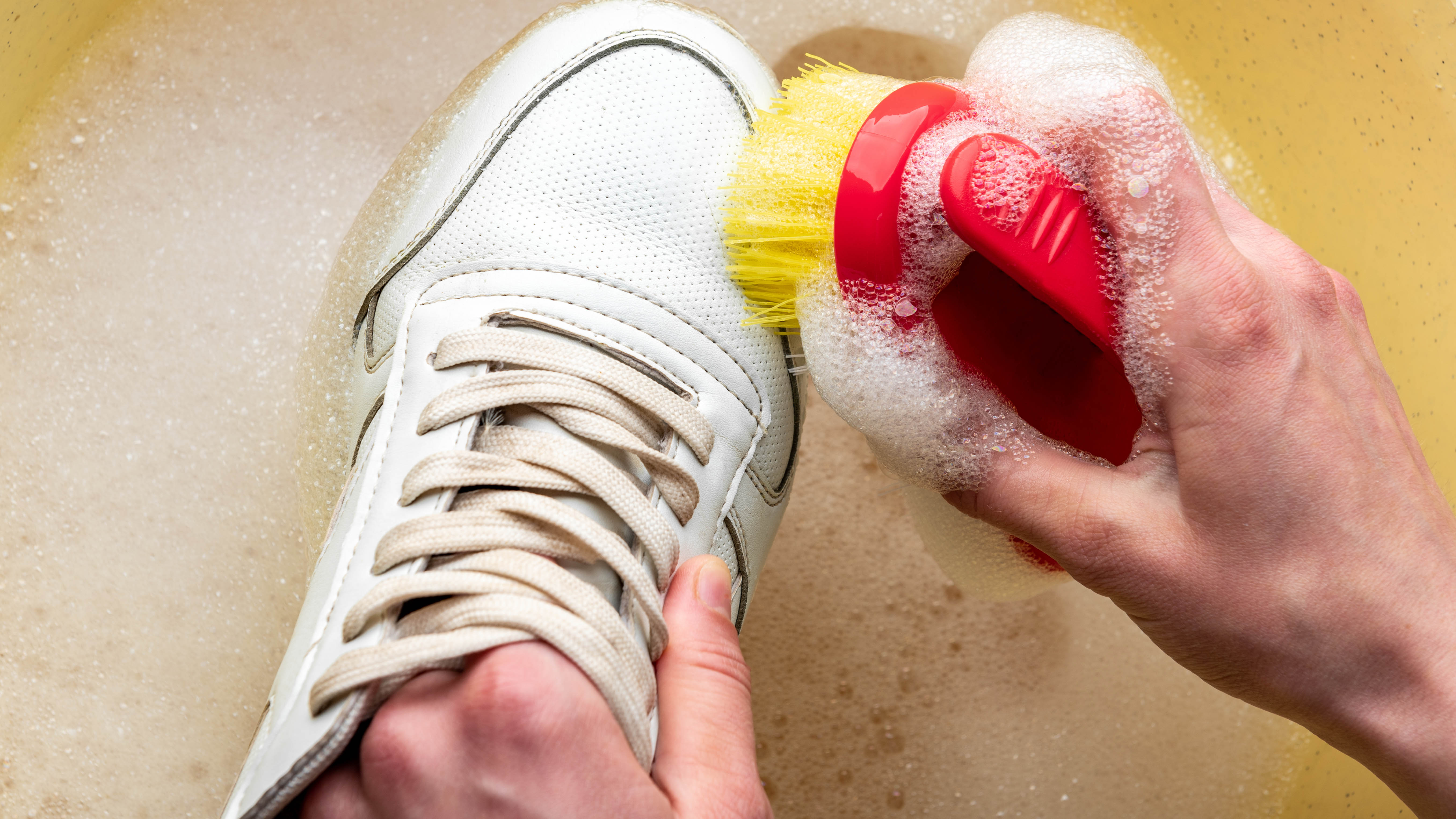 Clean sneakers in soapy water