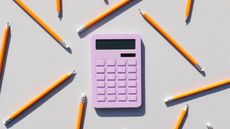 pink calculator surrounded by yellow pencils