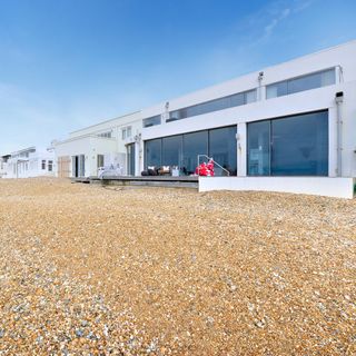 beach house with white walls and outside seating area