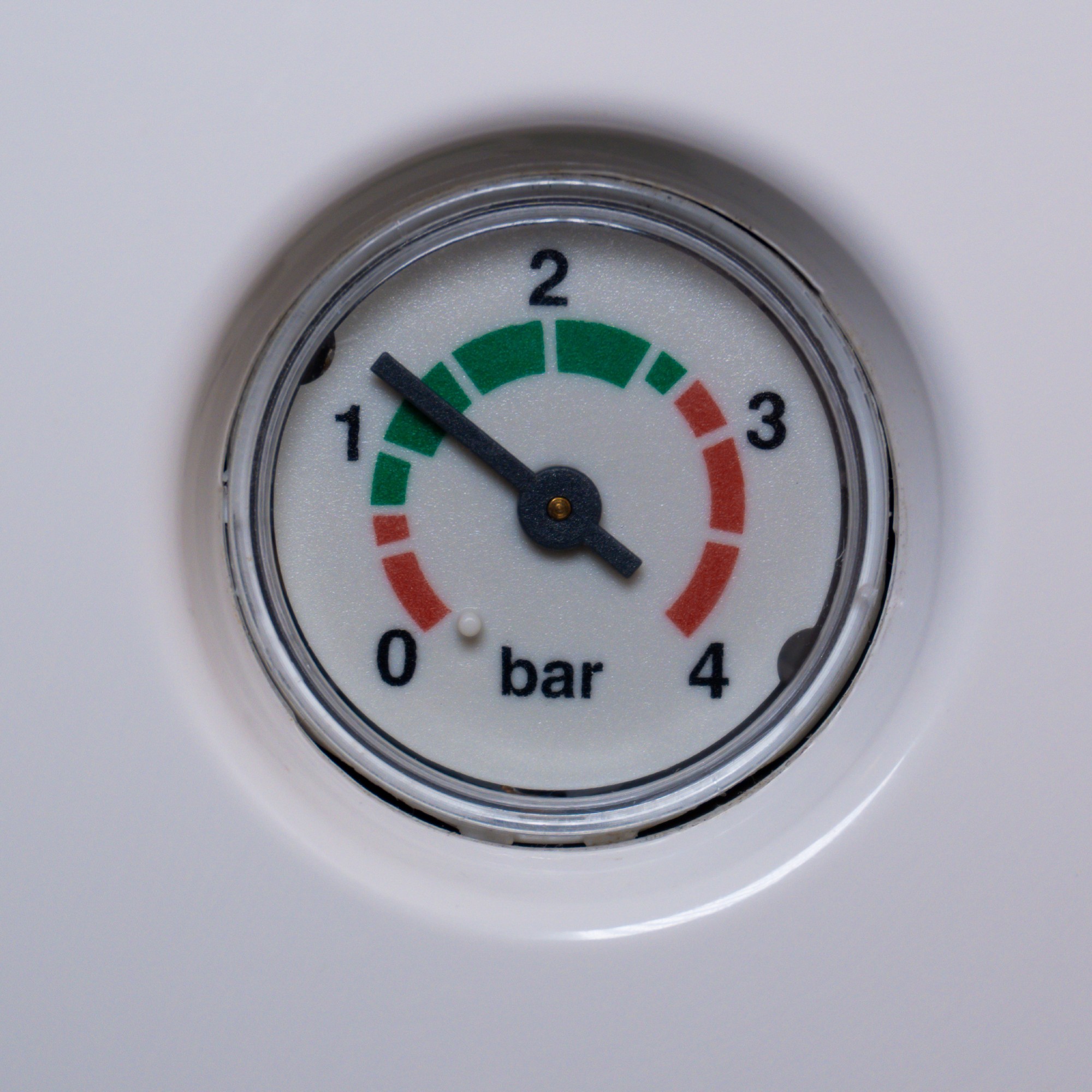 Close up of a boiler pressure gauge reading between 1 and 1.5 bar