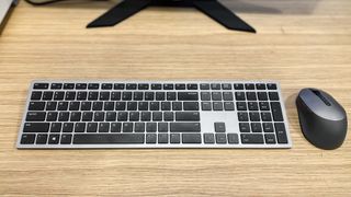Dell XPS 8950 keyboard and mouse sitting on a desk