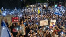 Protesters with flashlights on their phones during Tel Aviv demonstration