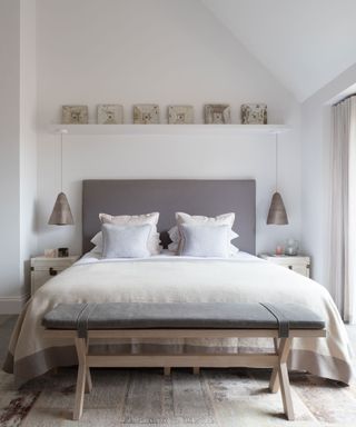 Neutral modern rustic bedroom in luxurious Cotswolds barn