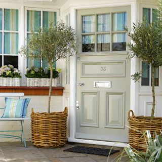 house entrance with outdoor seating and blue cushion