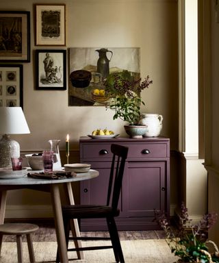 rustic dining room with purple sideboard and rustic vintage gallery wall of art