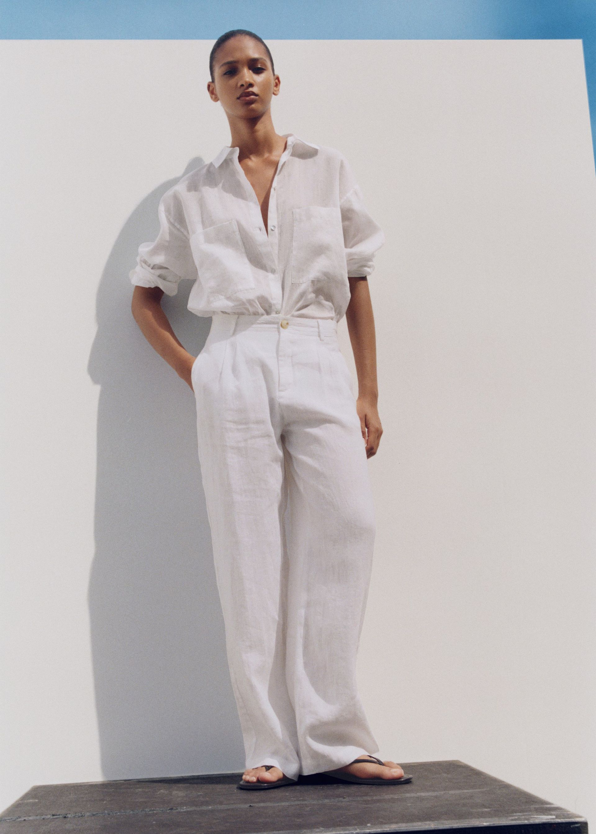 Woman wearing linen trousers and shirt