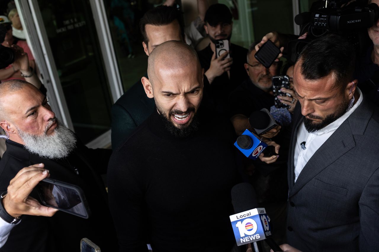 FORT LAUDERDALE, FLORIDA - FEBRUARY 27: Andrew Tate (C) and Tristan Tate (obscured) arrive in the United States after a travel ban on them was lifted, at the Fort Lauderdale-Hollywood International Airport on February 27, 2025 in Fort Lauderdale, Florida. The influencer brothers were arrested in late 2022 and charged with human trafficking alleging that they participated in a criminal ring that lured women to Romania, where they were sexually exploited. Andrew Tate was also charged with rape