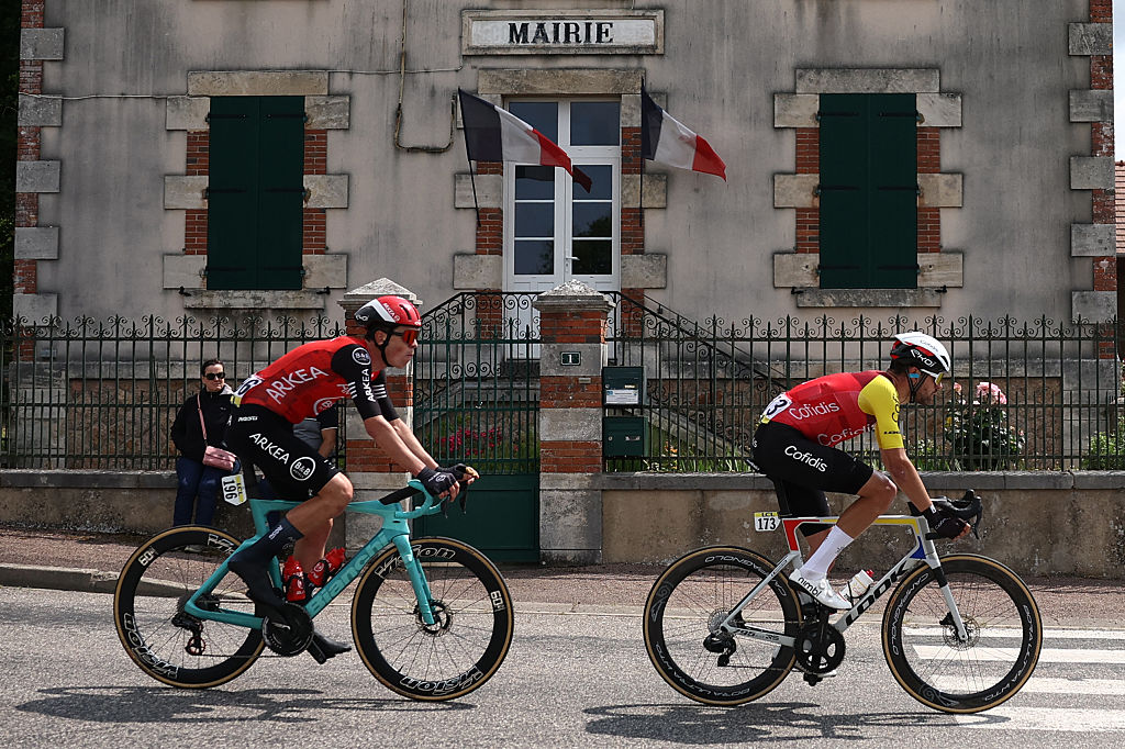 Arkea - B&B Hotels' French rider Thibault Guernalec (L) and Cofidis' French rider Paul Ourselin cycle in a breakaway past a townhall during the 1st stage of the 77th edition of the Criterium du Dauphine cycling race, 195,8 km between DomÃ©rat and Montlucon, on June 8, 2025. (Photo by Anne-Christine POUJOULAT / AFP)