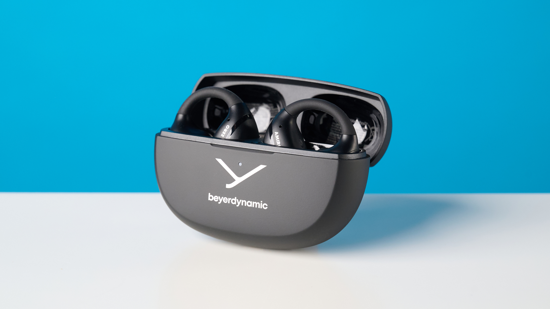 Beyerdynamic Amiron ZERO open-earbuds photographed on a blue background