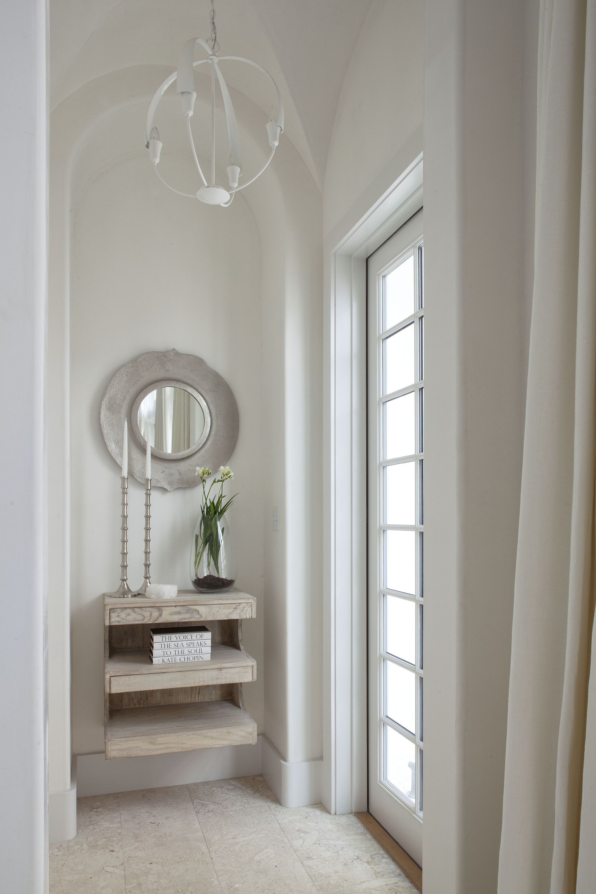 A small entryway with floating shelves