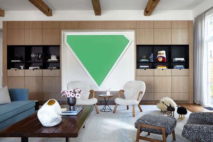 A room with a large green artwork