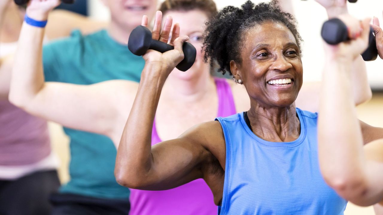 Older lady does a full body dumbbell workout