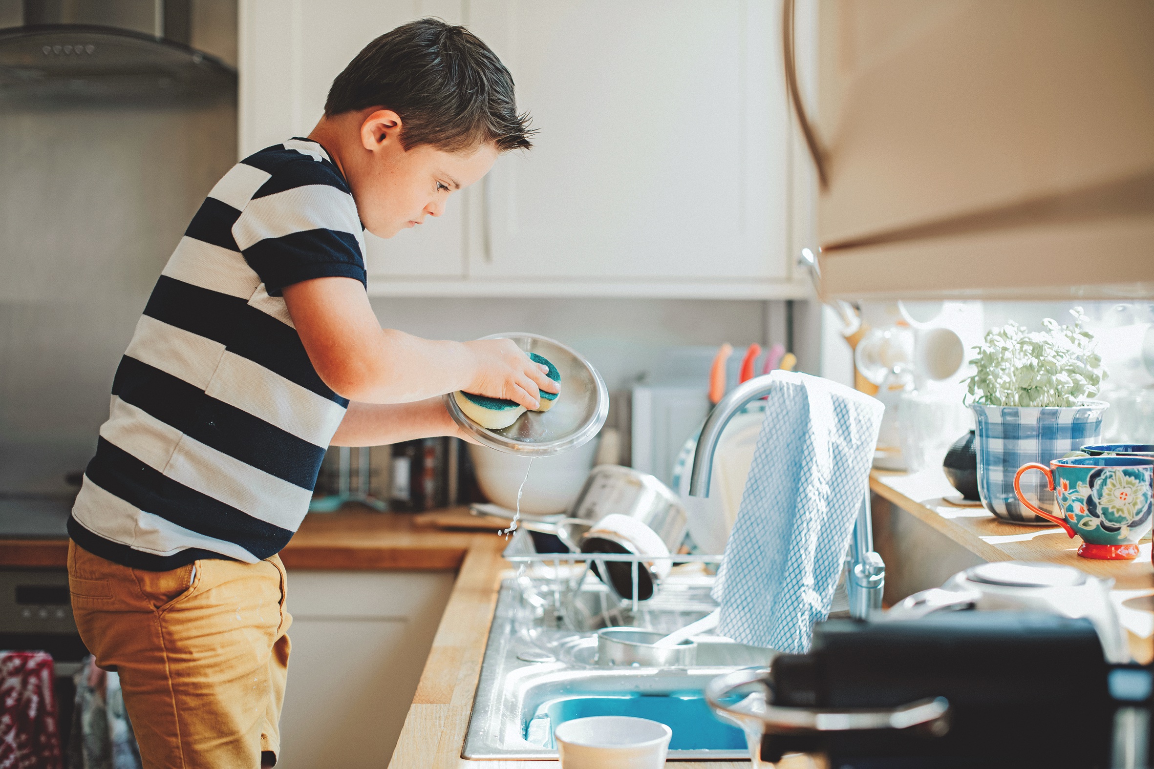 Boy washing the dishes