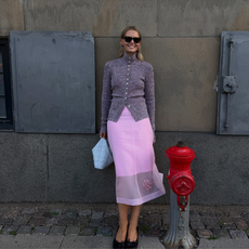Influencer Hollier Mercedes wearing a turtleneck cardigan, pink sheer skirt and ballet flats. 