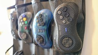 A close up shot of an over-the-door shoe hanger used to store gamepad controllers