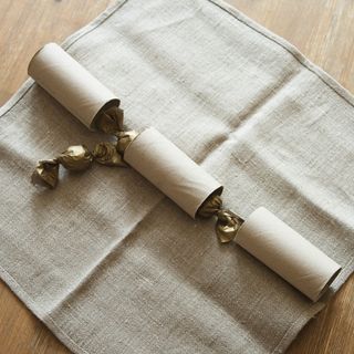 Three toilet rolls on napkin with chocolates