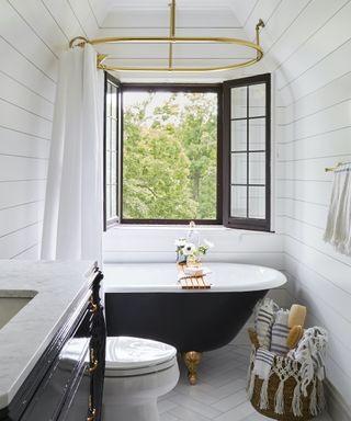 white bathroom with black tub