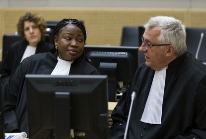ICC chief prosecutor Fatou Bensouda, left, speaks with deputy prosecutor James Stewart.