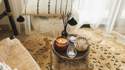 Cosy interior shot showing candle and diffuser on small table