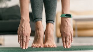 Woman doing yoga with fitness tracker
