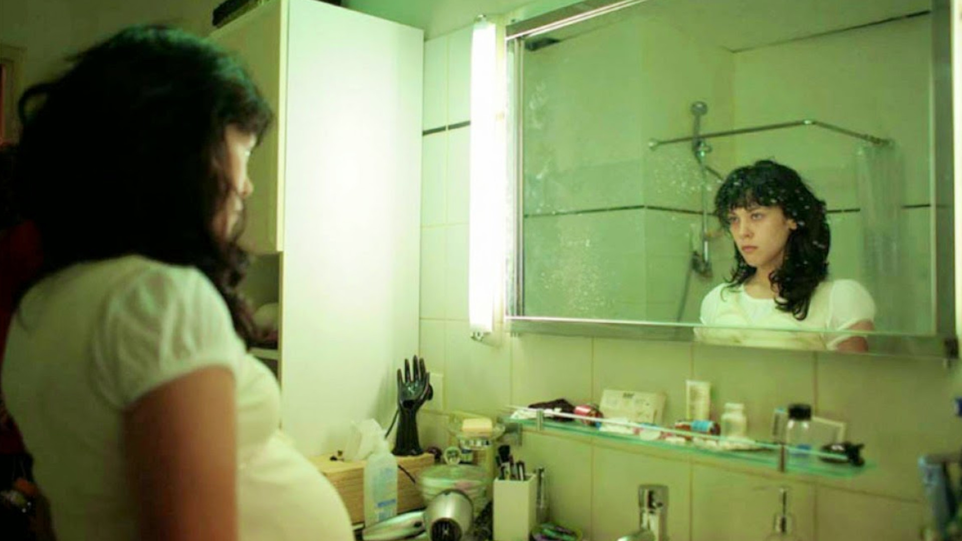 Alysson Paradis as Sarah Scarangella looking at herself in a mirror during one of the best scary movies, Inside.