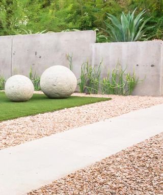 front yard landscaping with stone sculpture and gravel