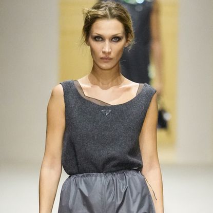 A photo of Bella Hadid walking in at the Prada F/W 26 show during Milan Fashion Week.