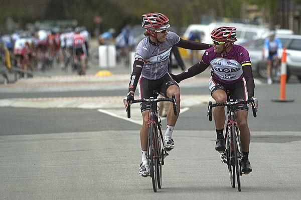 Tour leader Jonathan Cantwell (right) is congratulated by Fly V Australia teammate David Kemp after winning stage three into Barham.