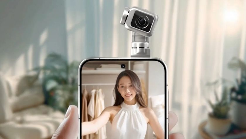 A hand holds a smartphone featuring a unique, motorized gimbal camera module on top that is pointed toward a woman displayed on the screen.