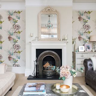 Living room with fireplace and floral patterned wallpaper
