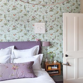 bedroom with floral wall and white door