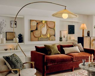 Soho Home orange velvet sofa in art filled living room space