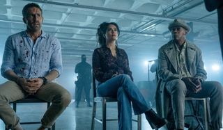 Ryan Reynolds, Salma Hayek, and Samuel L. Jackson sit as a captive audience in The Hitman's Wife's Bodyguard.