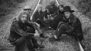 Rock group The Allman Brothers (L-R) Duane Allman, Dickey Betts, Gregg Allman, Jai Johanny Johanson, Berry Oakley and Butch Trucks sit on some rairoad tracks on May 5, 1969 outside of Macon, Georgia.