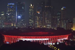 This photo taken on January 18, 2018 shows the fully-renovated Gelora Bung Karno Stadium lit up at night in Jakarta, which will be used for the opening and closing ceremonies of the 2018 Asian Games. - Indonesia will host the 2018 Asian Games in Jakarta and Palembang from August 18 to September 2.