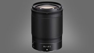 The Nikon Z 85mm f/1.8 S one a green background