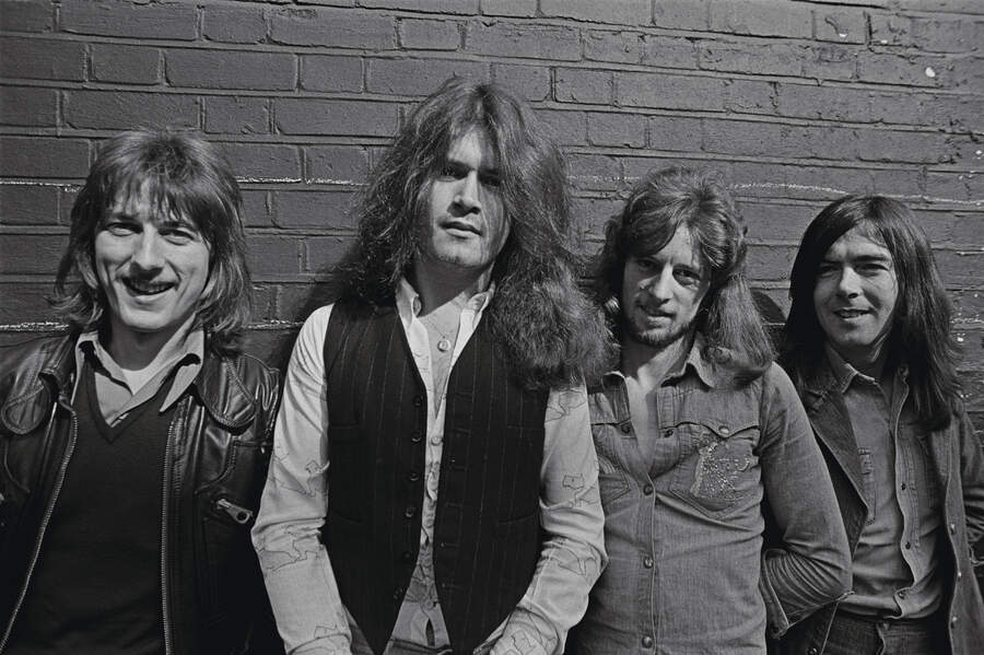 Trapeze pose in front of a brick wall, 1973