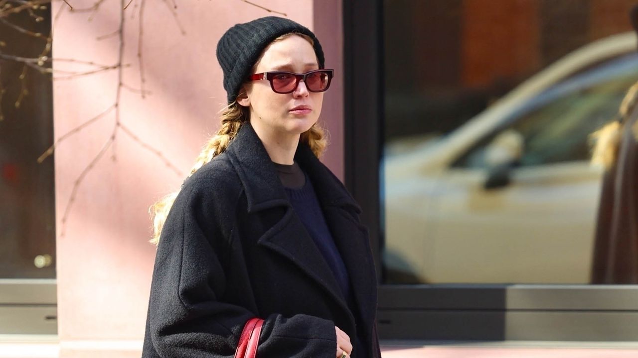 Jennifer Lawrence walks in Manhattan wearing a wool coat and the boat shoe trend paired to an Hermes tote