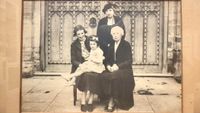 Black-and-white group portrait of four generations of women in the same family. 