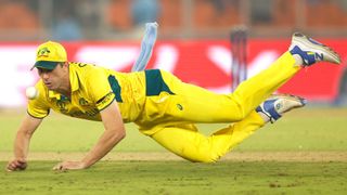 Pat Cummins dives for the ball ahead of the Australia vs Afghanistan live stream at the 2023 ICC Men's Cricket World Cup.