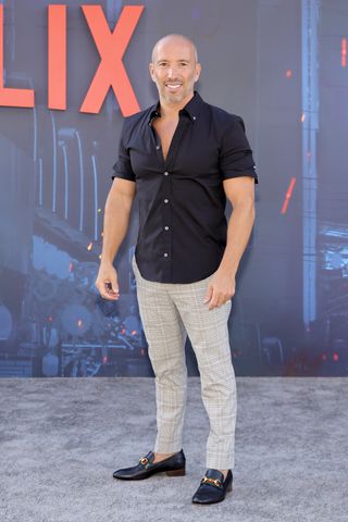 Jason Oppenheim posing on the red carpet at the premiere of The Gray Man on Netflix