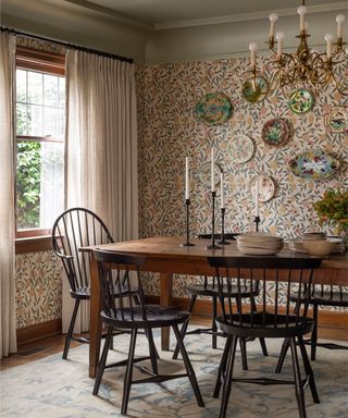 Cosy dining room with patterned wallpaper in 1920s Tudor revival house in Seattle