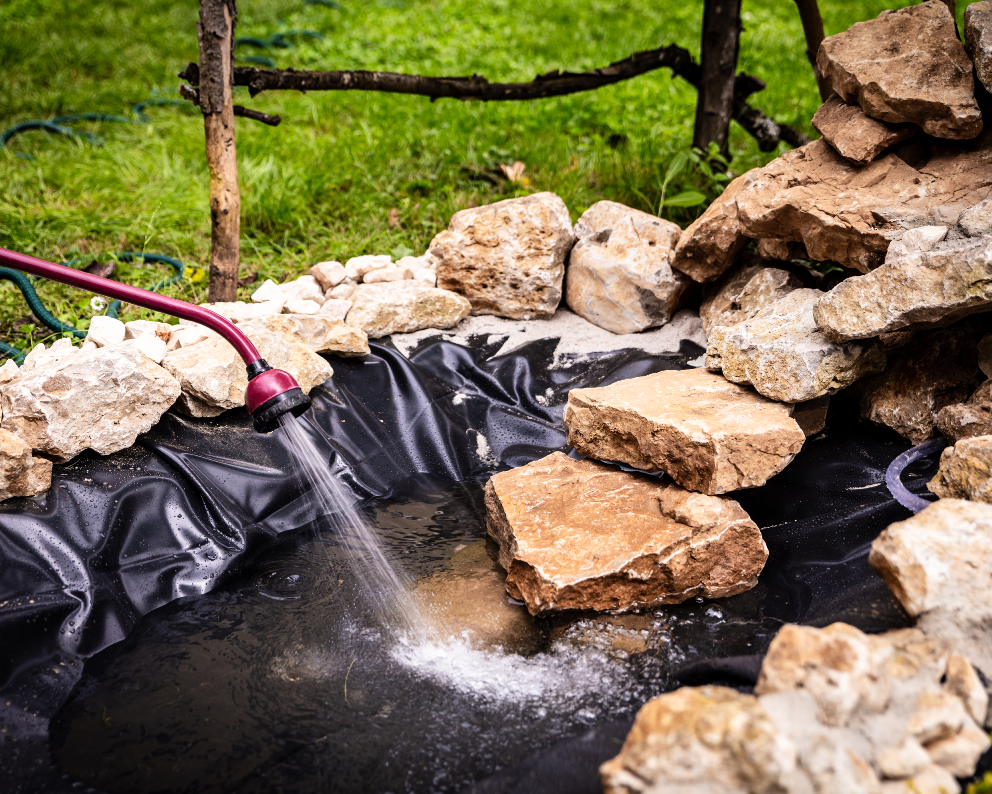 Filling new backyard wildlife pond with water
