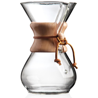 a glass coffee maker by Chemex with a wooden collar and a rawhide tie